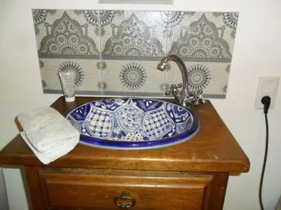 a blue and white sink on top of a wooden cabinet at Ceps Cottage sleeps 6 with free wifi near the river in Roquebrun