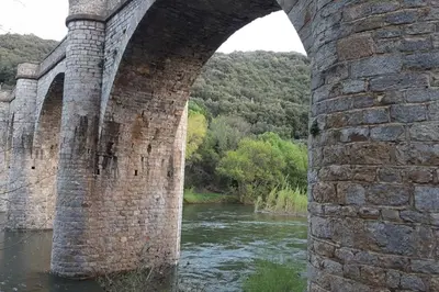 an old stone bridge over a river at Ceps Cottage sleeps 6 with free wifi near the river in Roquebrun