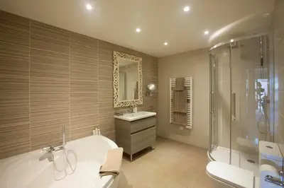a bathroom with a tub and a sink and a shower at Le Grenier in Carcassonne