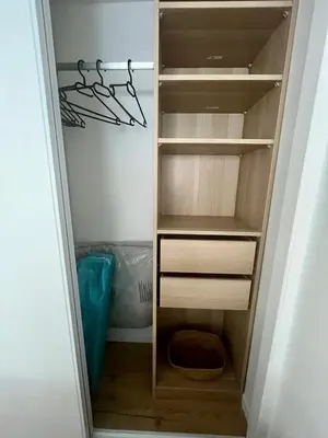 a walk in closet with wooden shelves at Charmant et Confortable appartement Narbonne in Narbonne