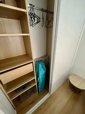 a small closet with wooden shelves in a room at Charmant et Confortable appartement Narbonne in Narbonne