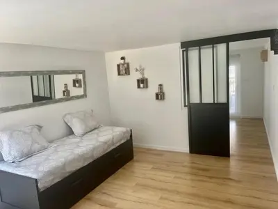 a living room with a couch and a mirror at Charmant et Confortable appartement Narbonne in Narbonne