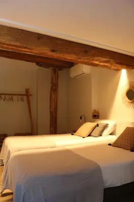 a room with two beds in a room at L'Echauguette, villa de luxe avec piscine au pied de la Cité in Carcassonne