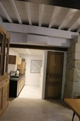 a kitchen with a door leading to a kitchen with a stove at L'Echauguette, villa de luxe avec piscine au pied de la Cité in Carcassonne