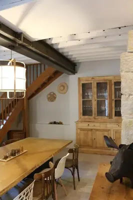 a dining room with a wooden table and chairs at L'Echauguette, villa de luxe avec piscine au pied de la Cité in Carcassonne