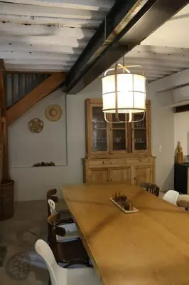 a dining room with a large wooden table and chairs at L'Echauguette, villa de luxe avec piscine au pied de la Cité in Carcassonne