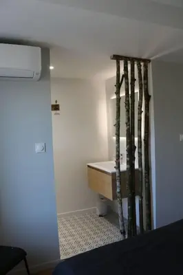 a room with a bathroom with a sink and a mirror at L'Echauguette, villa de luxe avec piscine au pied de la Cité in Carcassonne