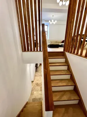 a staircase in a house with wooden railings at Le Margaux Balnéo spacieux calme in Conques-sur-Orbiel