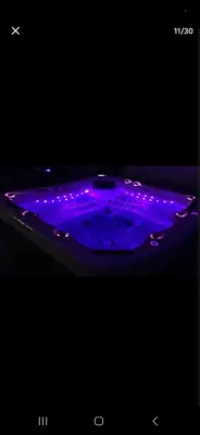 a purple bathtub with purple lights in a dark room at Bulle perchée in Sonnac-sur-lʼHers