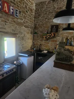 a kitchen with a counter top and a stove top oven at Bulle perchée in Sonnac-sur-lʼHers