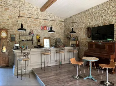 a bar with chairs and a piano in a room at Bulle perchée in Sonnac-sur-lʼHers