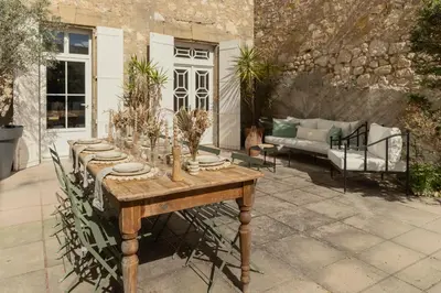 a wooden table with plants on top of a patio at Maison Esme - Charm & Authenticity in Salles-d'Aude