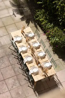 a wooden table with a group of white dishes on it at Maison Esme - Charm & Authenticity in Salles-d'Aude