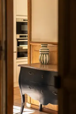 a vase sitting on top of a dresser in a kitchen at Maison Esme - Charm & Authenticity in Salles-d'Aude
