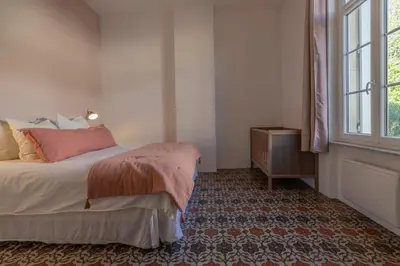 a bedroom with a bed and a window at Maison Esme - Charm & Authenticity in Salles-d'Aude
