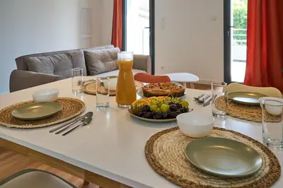 a table with plates and bowls of food on it at Le Rempart Harmonieux - Triplex au pied de la Cité in Carcassonne