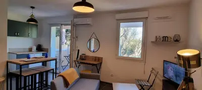 a living room with a couch and a table at Jardin des oiseaux in Narbonne