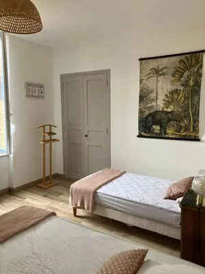 a bedroom with a bed and a painting on the wall at Maison Corbieres in Peyriac-de-Mer
