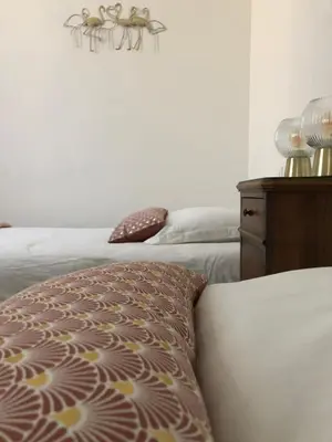a bedroom with a bed and a dresser at Maison Corbieres in Peyriac-de-Mer