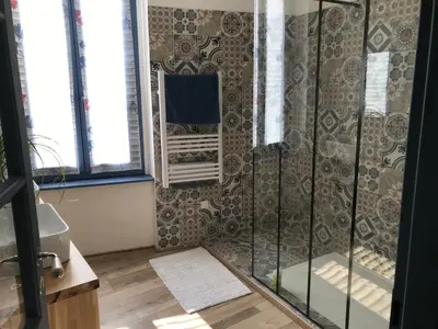 a shower with a glass door in a bathroom at Maison Corbieres in Peyriac-de-Mer