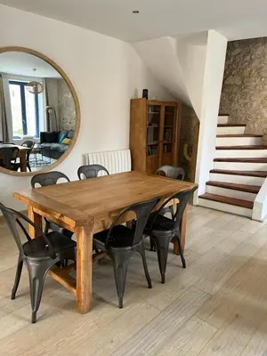 a dining room table with chairs and a mirror at Maison Corbieres in Peyriac-de-Mer