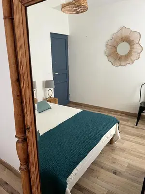 a bedroom with a bed with a wooden frame at Maison Corbieres in Peyriac-de-Mer