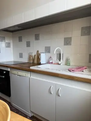 a kitchen with a white sink and a counter at La maison de la gare in Carcassonne
