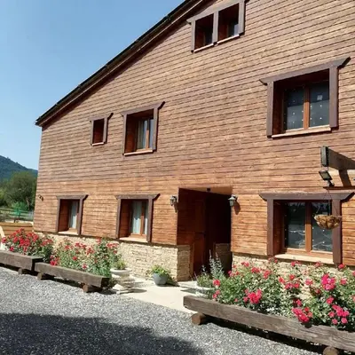 a wooden building with flowers in front of it at Chalet 