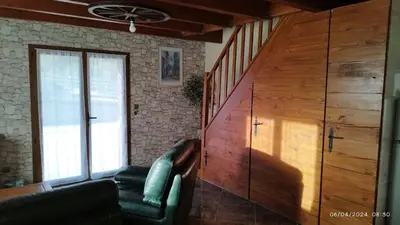 a living room with a couch and a wooden wall at Chalet 