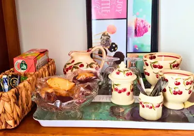 a table topped with vases and a bowl of food at La petite maison de Valérie proche château de la Rode, du Domaine de Flore et du Lac Saint Ferréol in Lempaut