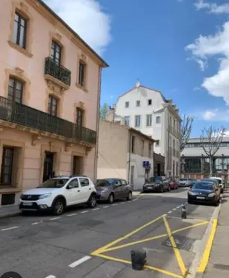 a city street with cars parked in a parking lot at Studio Valliere les halles 15m2 avec clim in Narbonne