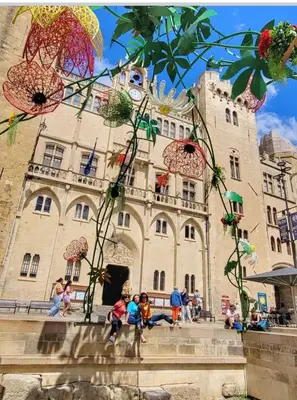 a group of children sitting in front of a building at Studio Valliere les halles 15m2 avec clim in Narbonne