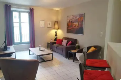a living room with a couch and a table at Résidence Armagnac - City Center in Carcassonne