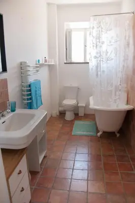a bathroom with a tub and a toilet and a sink at Maison Pelissier Bed and Breakfast with swemming pool in Cuxac-dʼAude