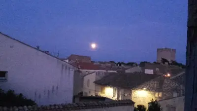 a view of a city at night with a moon at Maison Pelissier Bed and Breakfast with swemming pool in Cuxac-dʼAude