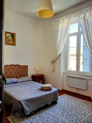 a bedroom with a bed and a large window at Maison Pelissier Bed and Breakfast with swemming pool in Cuxac-dʼAude