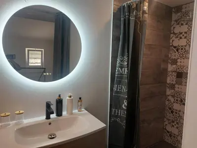 a bathroom with a sink and a mirror at La Parenthèse in Moussan