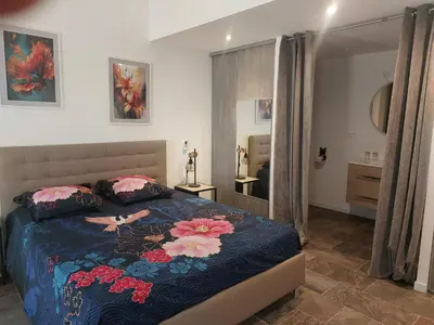 a bedroom with a bed with a woman on it at La Parenthèse in Moussan