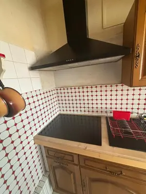 a kitchen with a counter top with a stove top at L'Arbousier in Port-la-Nouvelle