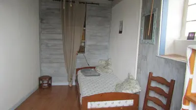 a small room with a bed and a table and chairs at Maison Minervoise in Aigne