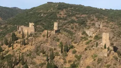 a castle on the side of a mountain at Maison Minervoise in Aigne