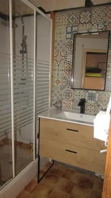 a bathroom with a sink and a mirror and a shower at Maison Minervoise in Aigne