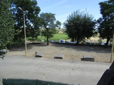 a park with three benches and a street light at Maison Minervoise in Aigne