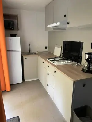 a dining room with a table and chairs and a couch at Camping 3 étoiles - ccaaafd in Sorèze
