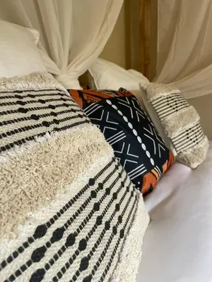 a bed with a black and white blanket and pillows at Serengeti Safari Room in Sigean