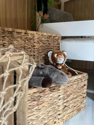 a stuffed teddy bear sitting in a basket at Serengeti Safari Room in Sigean
