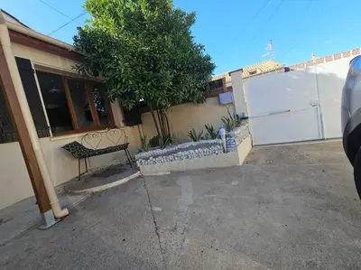 a bench sitting outside of a house at La Casa D'Eole YourHostHelper in Narbonne