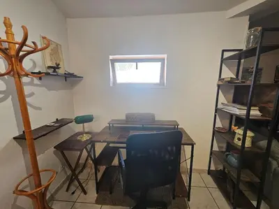 a room with a table and a chair and a window at La Casa D'Eole YourHostHelper in Narbonne