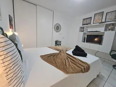 a white room with a bed and a television at La Casa D'Eole YourHostHelper in Narbonne