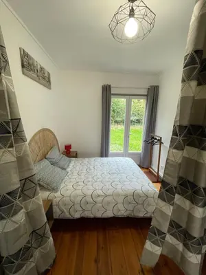 a bedroom with a bed and a window at Maison avec vue sur le Lac de Montbel in Montbel
